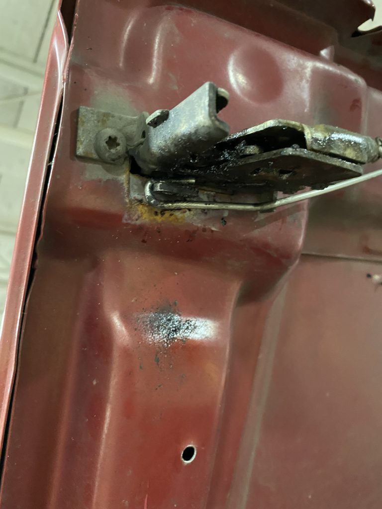 Hood Rod Being Removed From Hood Latch